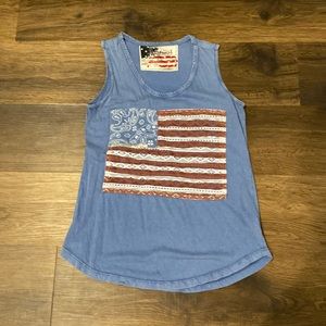 Sleeveless red, white and blue tee with flag emblem. Size S